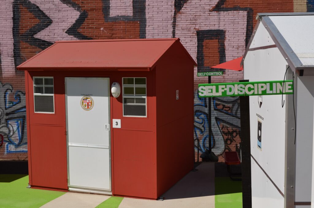 Red Pallet shelter and a sign reading self-discipline at Westlake Village