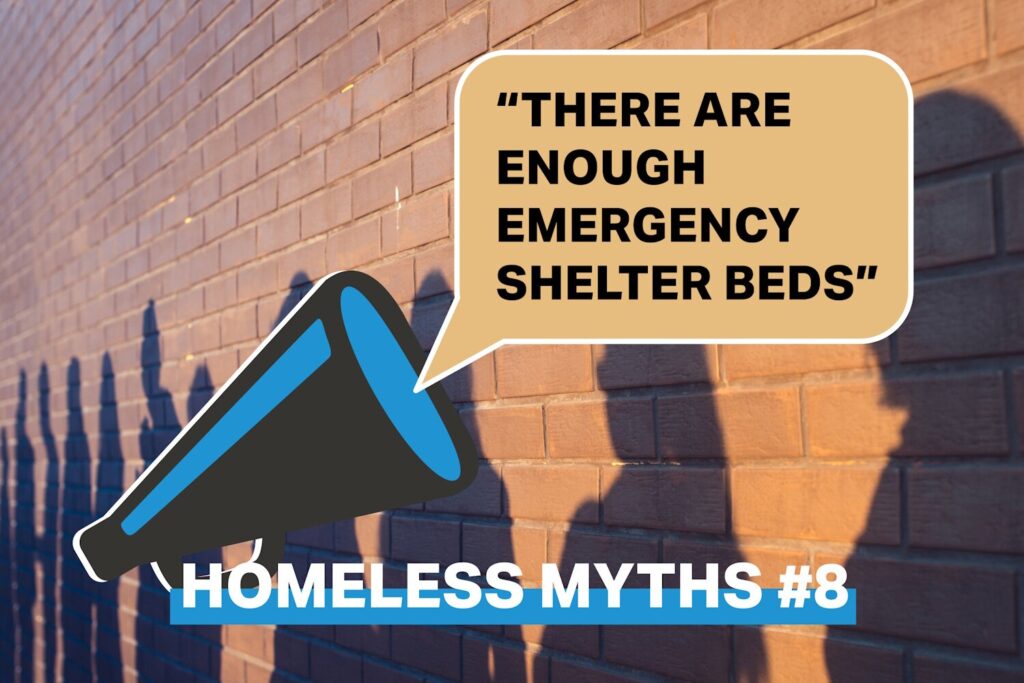 Bullhorn with a word bubble stating "There are enough emergency beds" Bottom of graphic says Homeless Myths #8 over a brick wall.